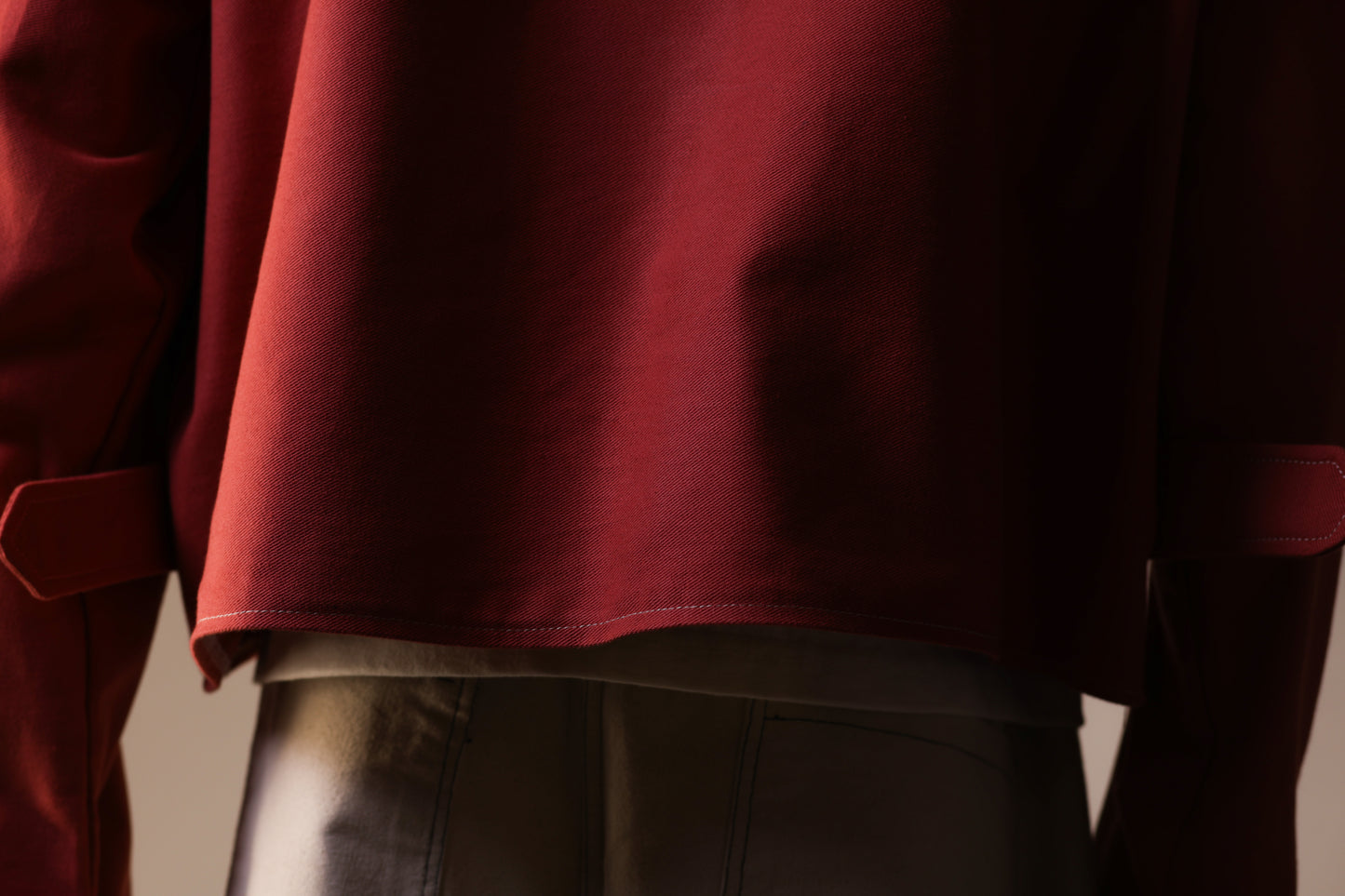 Close-up of a person wearing a red garment with a blurred background